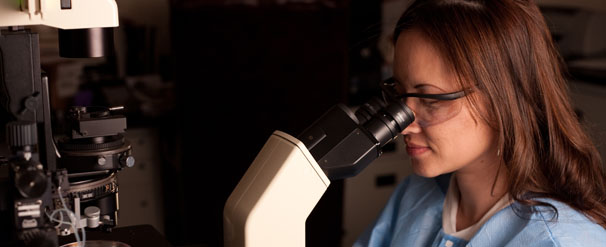 lab analyst with microscope